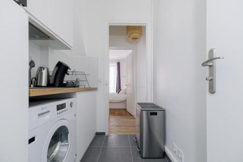 une cuisine blanche avec lave-linge dans l'établissement Flexliving - room - Caulaincourt, à Paris