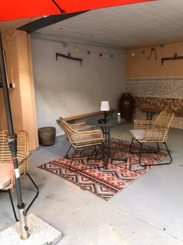 a patio with a table and chairs on a rug at Excellent house in Ediger-Eller