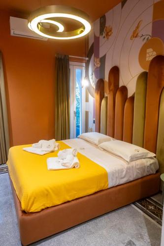 a bedroom with a large bed with towels on it at Residencia Barrio B&b - 3 suites - 6 Minutes from Amalfi Coast in Cava deʼ Tirreni