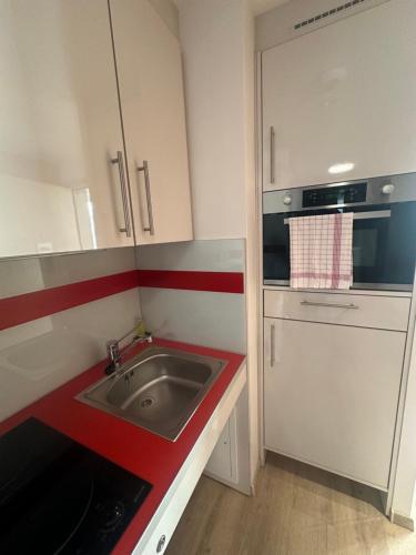 a small kitchen with a sink and a stove at ZENAO Fréjus in Fréjus