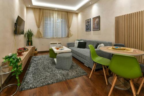 a living room with a couch and a table at Lux apartman Popovic in Zlatibor