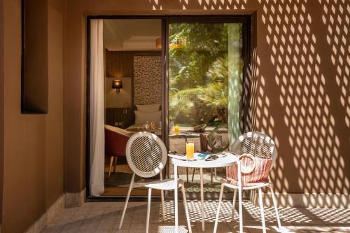 a table and chairs sitting on a patio at Barceló Palmeraie Oasis Resort in Marrakech