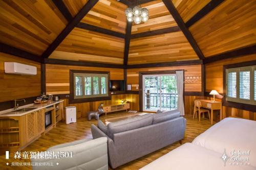 a living room with a couch and a table at 日月潭森堡萊夫莊園 in Yuchi