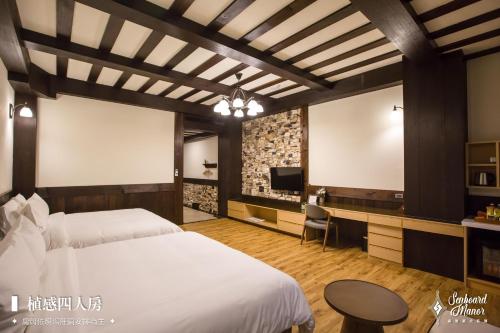 a hotel room with a bed and a tv at 日月潭森堡萊夫莊園 in Yuchi