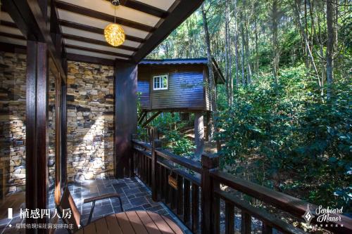 a balcony of a cabin in the woods at 日月潭森堡萊夫莊園 in Yuchi