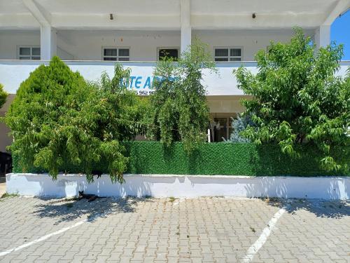 two trees in front of a building at Elite Apart Pansiyon in Gokceada Town