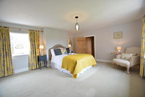 a bedroom with a bed and a yellow blanket at Rookyards in Spexhall