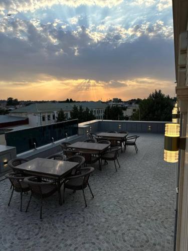 a group of tables and chairs on a roof at Next Hotel Samarkand in Samarkand