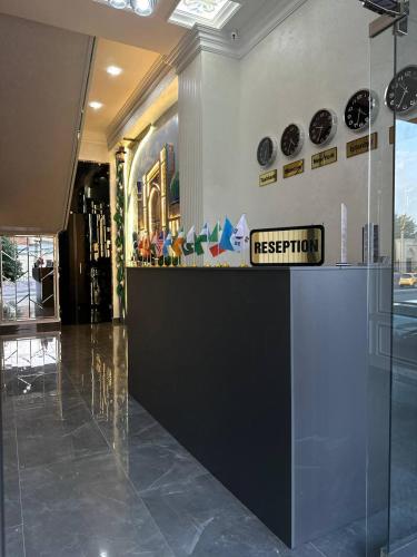 a lobby with a reception desk in a building at Next Hotel Samarkand in Samarkand