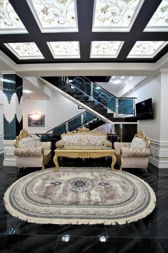 a living room with a couch and a large rug at Next Hotel Samarkand in Samarkand
