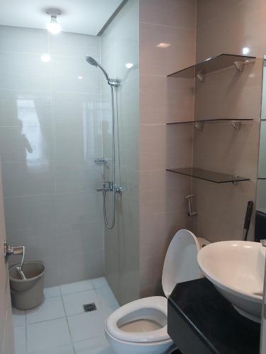 a bathroom with a shower and a toilet and a sink at Pasay Staycation with Parking Space in 150 Newport Boulevard near Resort World & NAIA T3 in Manila