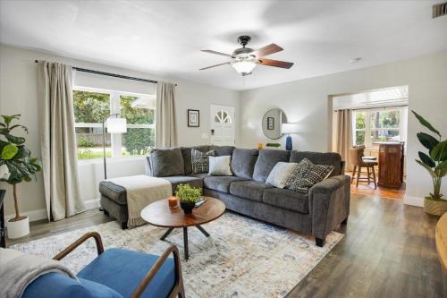 a living room with a couch and a table at The Canopy on 10th - Game Room , Pets , Pergola in Gainesville