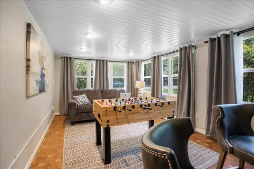a living room with a foosball table and chairs at The Canopy on 10th - Game Room , Pets , Pergola in Gainesville