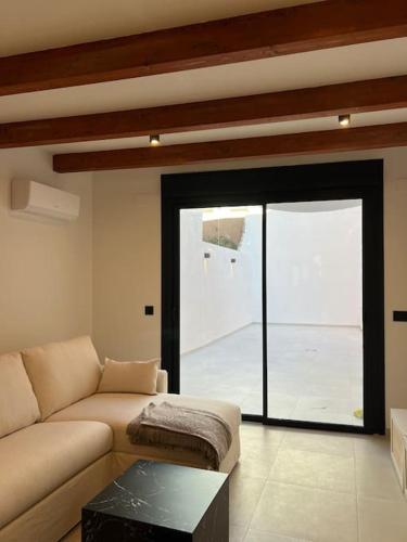 a living room with a couch and a large window at Carud Nº15 in Monforte de Lemos
