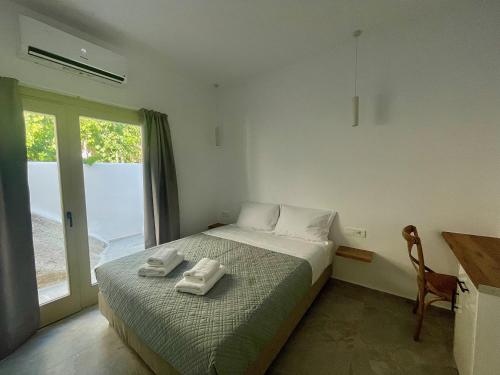 a bedroom with a bed with towels on it at Casa Suites Mykonos in Agios Stefanos