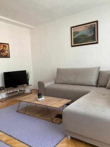 a living room with a couch and a coffee table at Trpejca Holiday Home in Trpejca