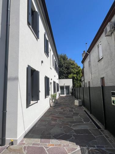 an alley between two buildings with a fence at House of Flowers in Spinea