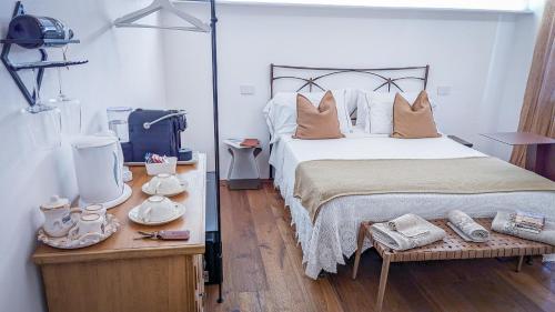 a bedroom with a large bed and a table with dishes at MontepulcianoLettings in Montepulciano