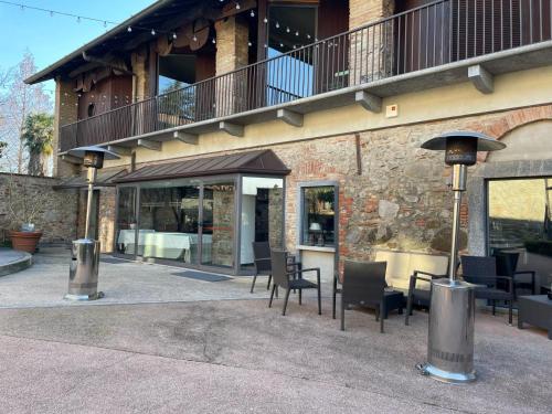 a building with chairs and tables and a balcony at LEAR • Dining Club in Briosco