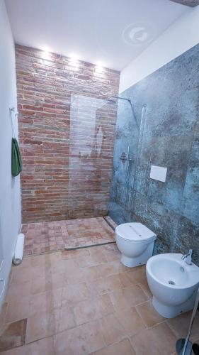 a bathroom with a shower and a toilet and a sink at MontepulcianoLettings in Montepulciano
