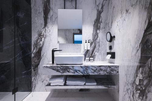 a bathroom with a sink and a mirror at Crowne Plaza Constanta - Mamaia Beach by IHG in Mamaia