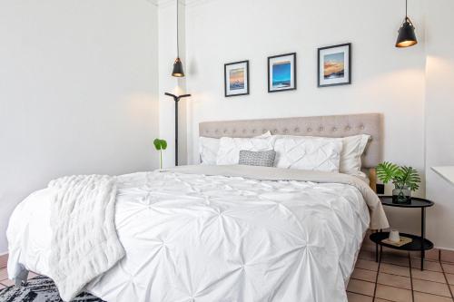 a white bedroom with a bed with white sheets at Casa Palma 2 in La Paz