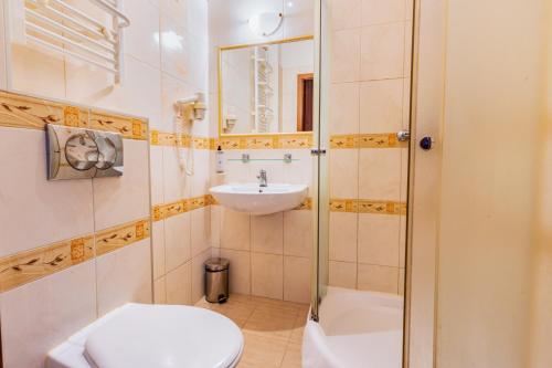 a bathroom with a toilet and a sink and a shower at Noclegi Stadion Bed & Breakfast in Warsaw