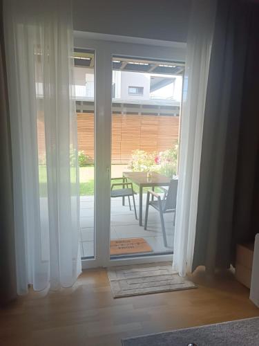 an open door to a patio with a table at Brunnenpark Ruhepol in Bad Radkersburg