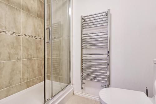 a bathroom with a shower and a toilet at ESSEX Basildon 4 bedroom house 2 half bath in Basildon