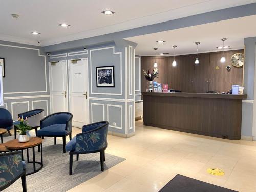 a waiting room with chairs and a counter at Hôtel Central Saint Germain in Paris