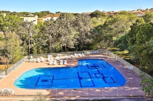 - une vue sur la piscine et ses chaises dans l'établissement Centre St Tropez - Gd 2 pièces, piscine et parking, à Saint-Tropez