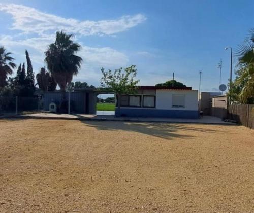 a house with a dirt road in front of it at La Caseta Dels Avis in Sant Jaume d'Enveja