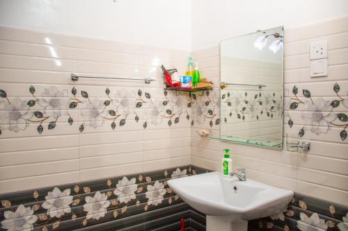 a bathroom with a sink and a mirror at Nice View Lodge in Sigiriya