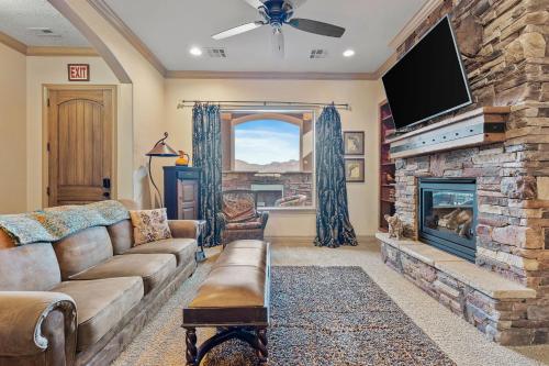a living room with a couch and a fireplace at The Condo at Coral Springs Resort in Hurricane