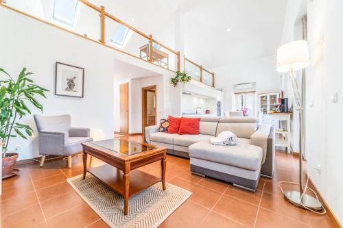 a living room with a couch and a table at Quinta da Asneira in Montemor-o-Novo
