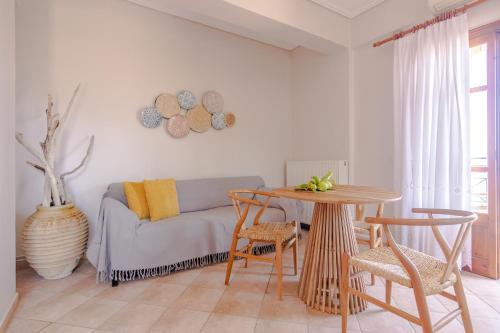 a living room with a couch and a table at Pelagia Apartments in Koroni