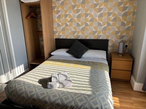 a bedroom with a bed with two towels on it at Central Hotel in Sutton in Ashfield