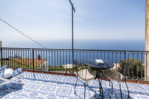 a balcony with a table and chairs and a view at Salvo's House in Furore