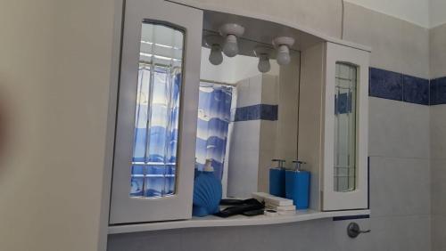 a bathroom with two mirrors and a sink at Casa Blu Loft in Néa Ankhíalos