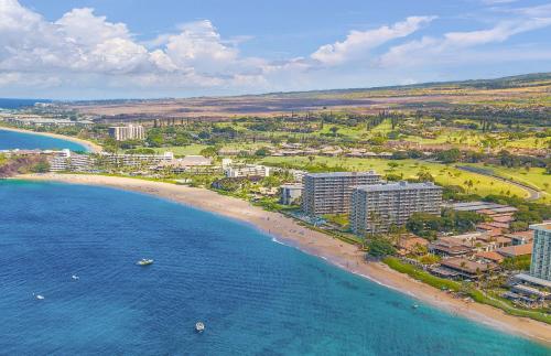 an aerial view of a beach with buildings and the ocean at The Whaler By Maui Resort Rentals in Lahaina