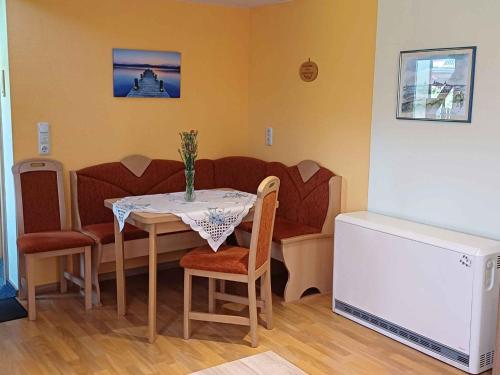 a living room with a table and a couch at Holiday Home Uckeritz - Seebad 1 in Ueckeritz