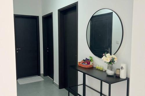 a bathroom with a black table and a mirror at Near AlQurum Beach, Free Parking in Muscat