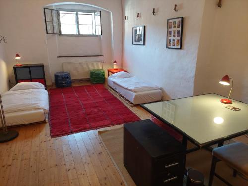 a living room with two beds and a glass table at Cool Flat at Renaissance Castle - 3BR in Ilz