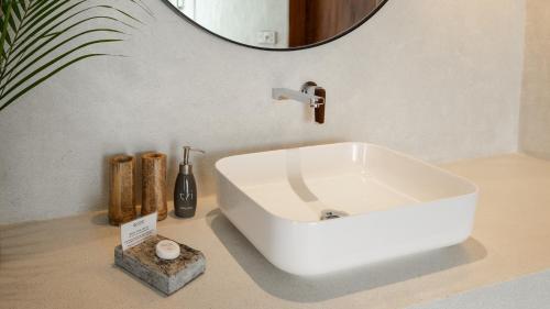 a white sink in a bathroom with a mirror at Tri by Amaya in Ahangama