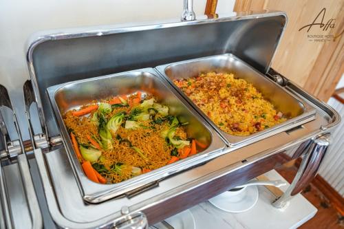 a tray of food with broccoli and rice at Affa Boutique Hotel in Hanoi