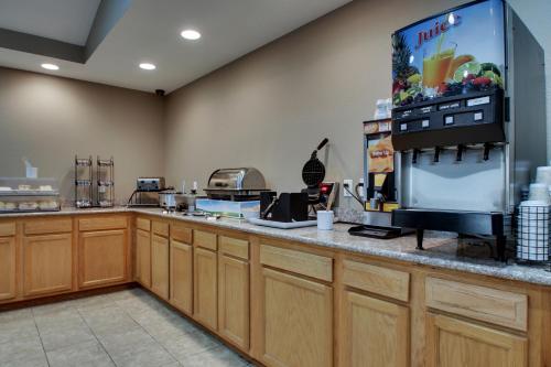 a kitchen with a counter with a large refrigerator at EverSpring Inn & Suites in Oskaloosa