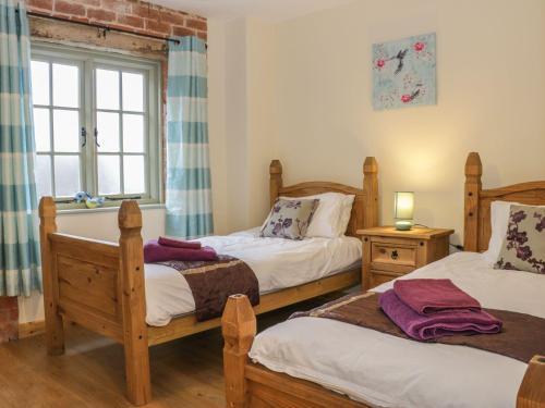 Ένα ή περισσότερα κρεβάτια σε δωμάτιο στο Orchard Cottage