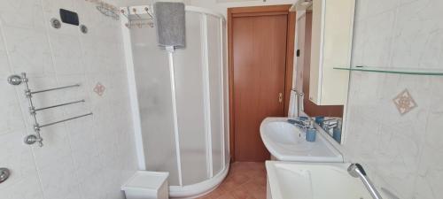 a bathroom with a shower and a toilet and a sink at Casa Vacanze Galatro in Sapri