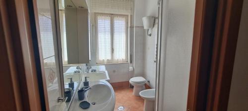 a bathroom with a sink and a toilet and a mirror at Casa Vacanze Galatro in Sapri