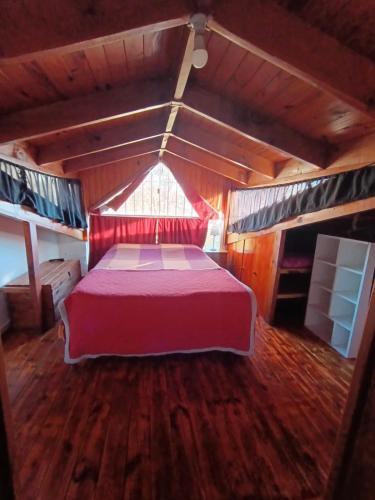 a bedroom with a large bed in a wooden room at Casita azul Bariloche in San Carlos de Bariloche